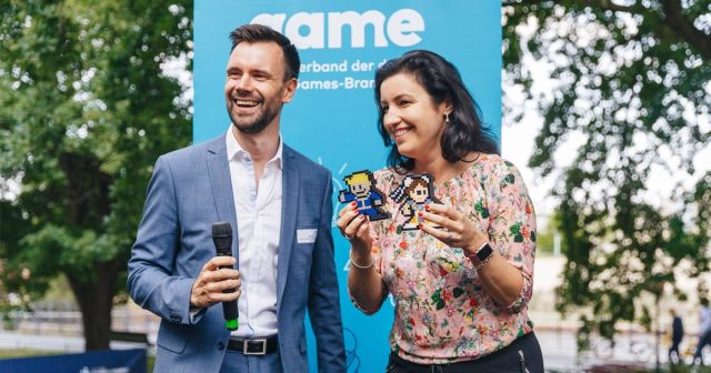 Game-Geschäftsführer Felix Falk bedankt sich bei Digitalstaatsministerin Dorothee Bär (CSU) mit zwei Videospiel-Figuren, die einen Platz im Kanzleramt finden sollen (Foto: Game-Verband / Jakob Nawka)